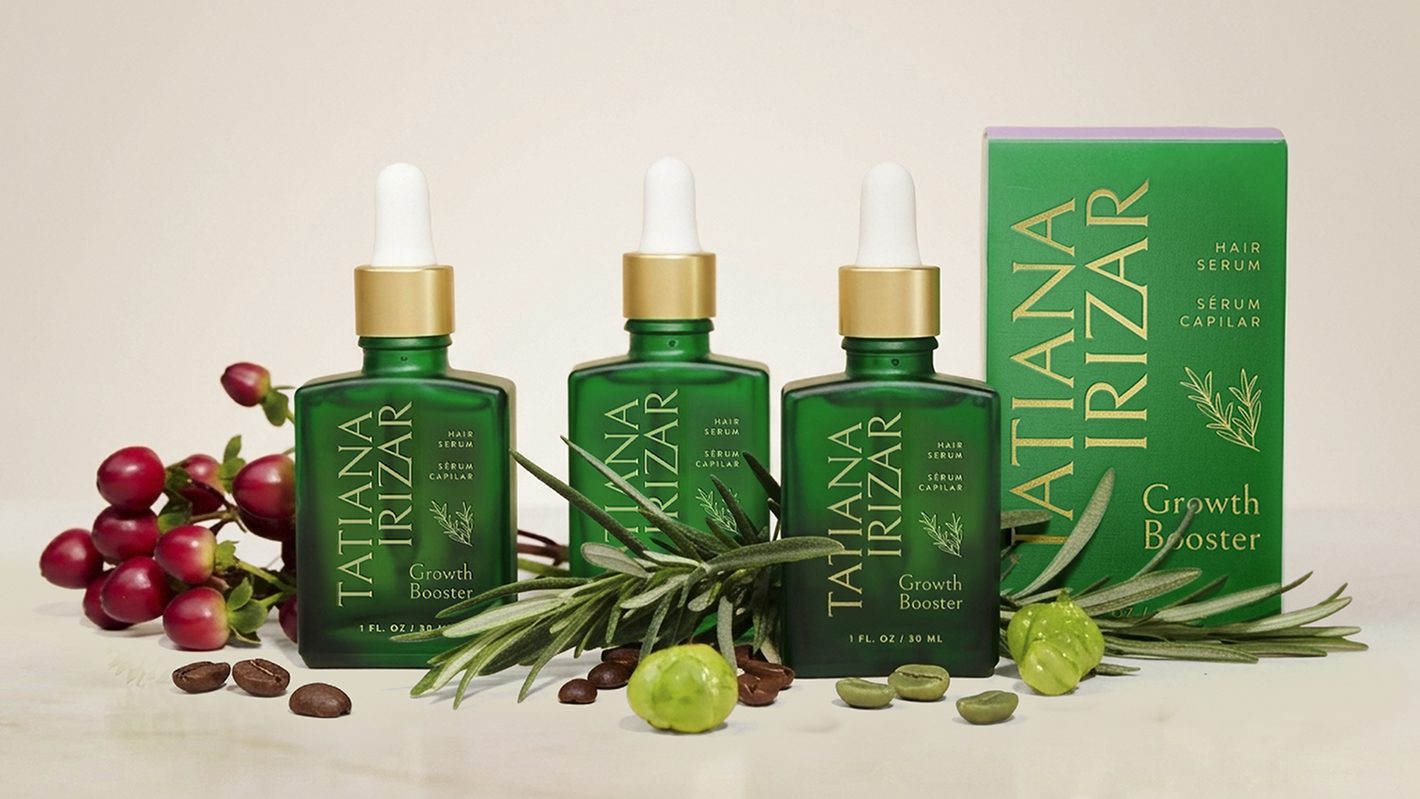 Tatiana Irizar Growth Booster product line with bottles, box, and botanical ingredients