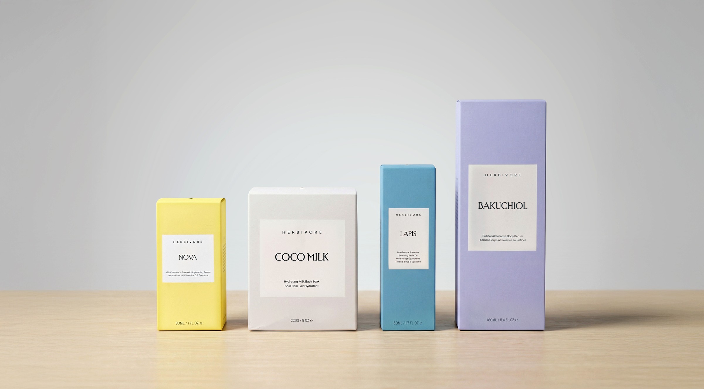 Current Herbivore secondary packaging boxes on a wooden surface