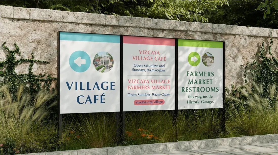 Vizcaya wayfinding signage with custom icons mounted on a stone garden wall