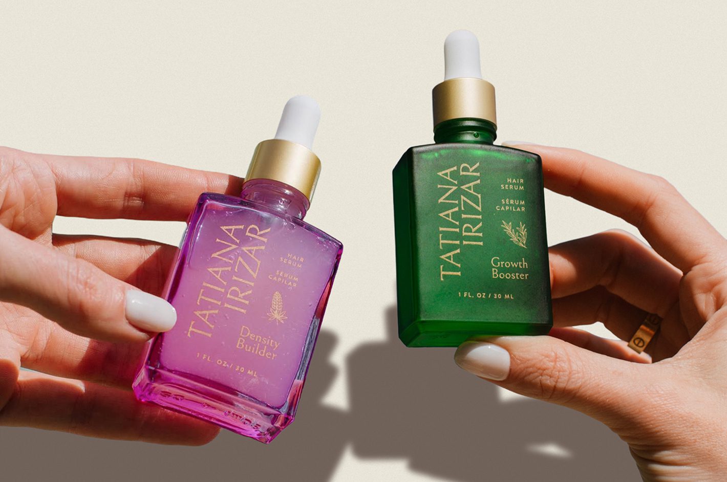 Tatiana Irizar purple and green hair serums held side by side as a coordinated product system