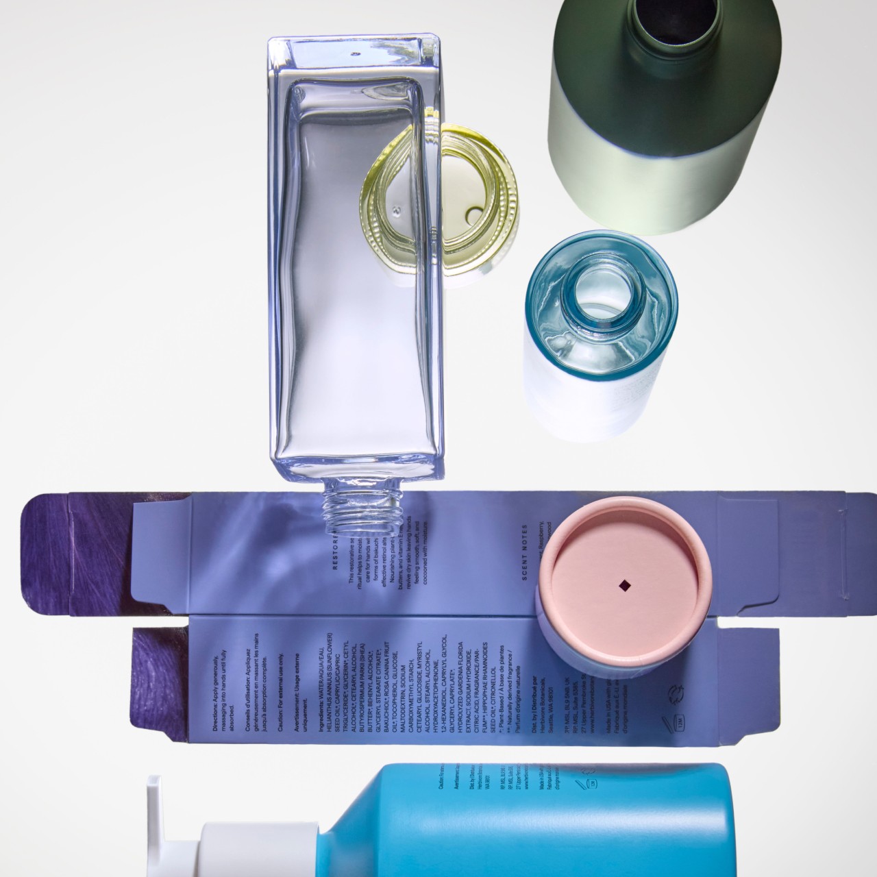 Herbivore bottles and packaging arranged flat lay