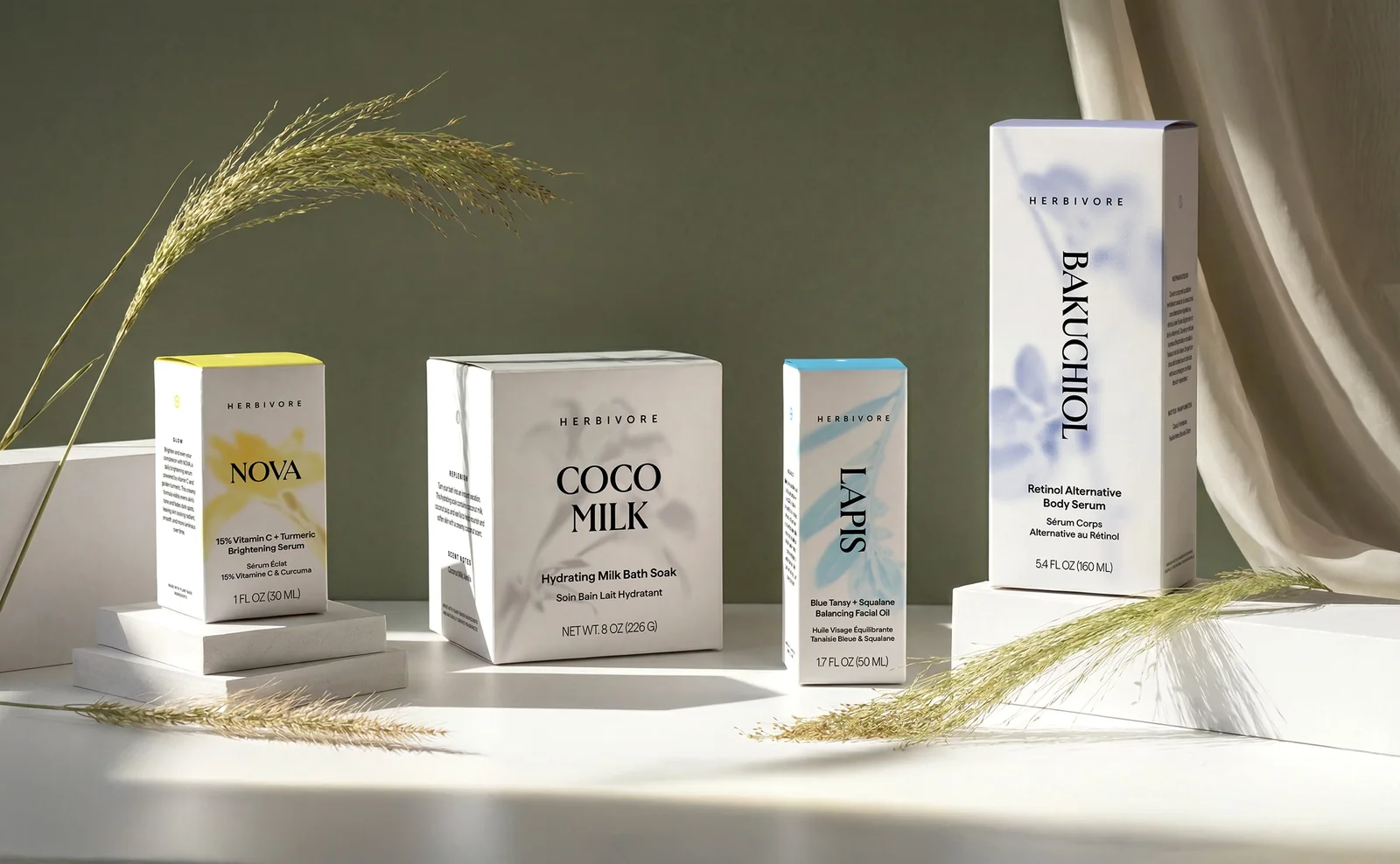 Refreshed Herbivore boxes with botanical illustrations, opened to show inverted color inside