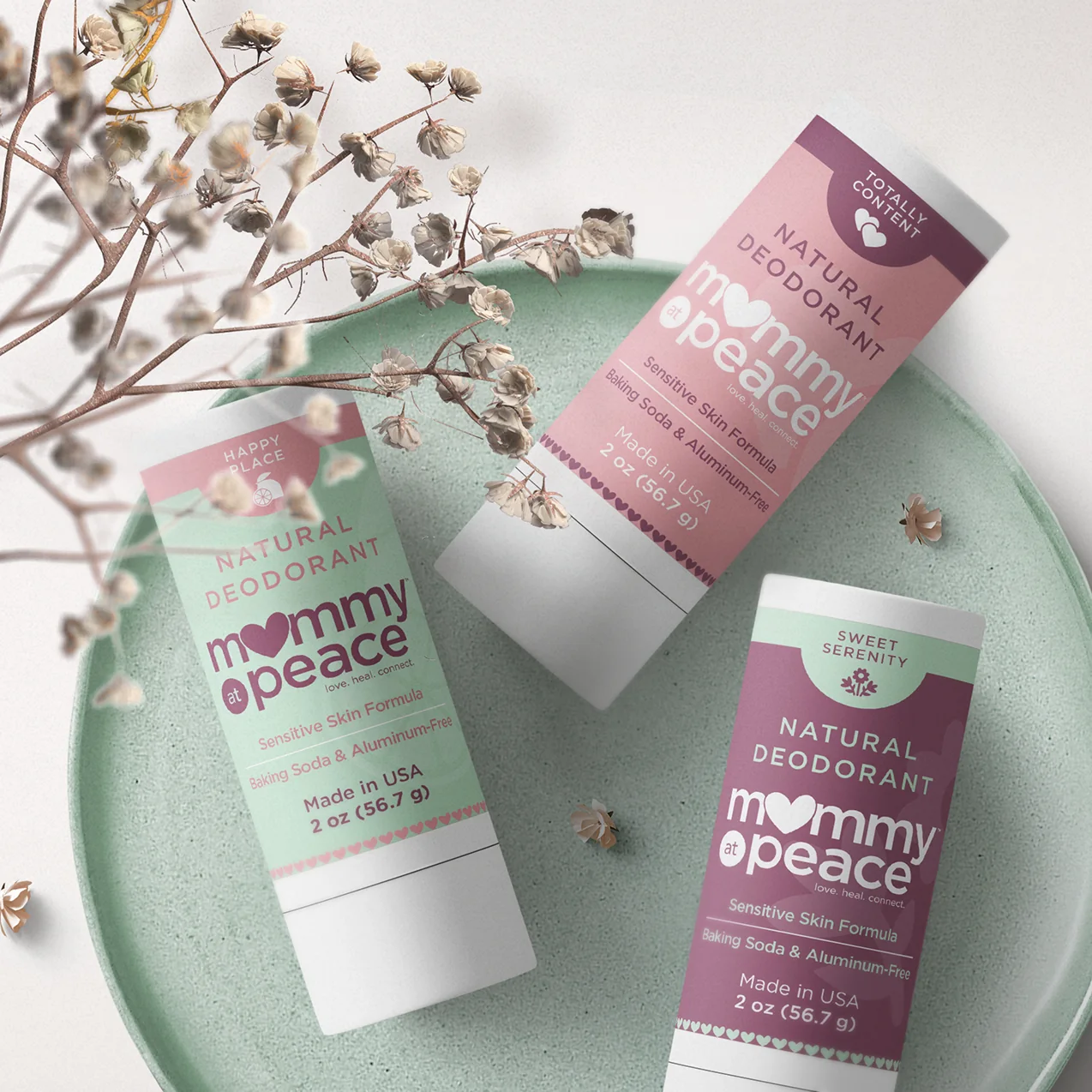 Mommy at Peace natural deodorant packaging arranged with dried botanicals