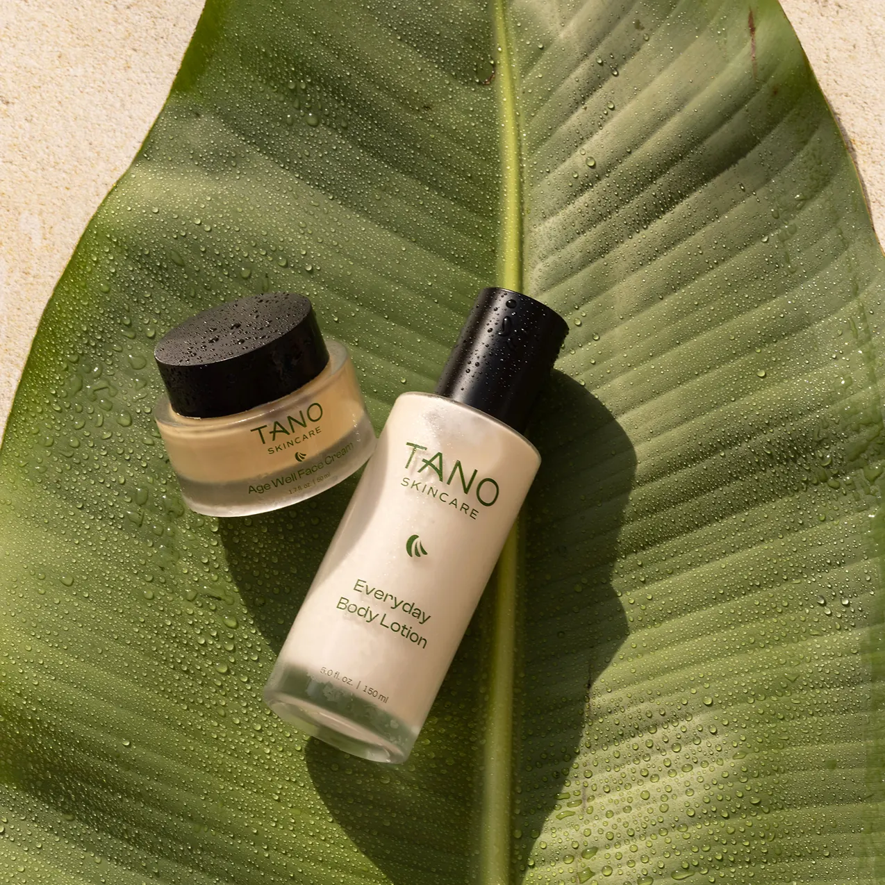 Tano skincare products presented on a glossy green leaf